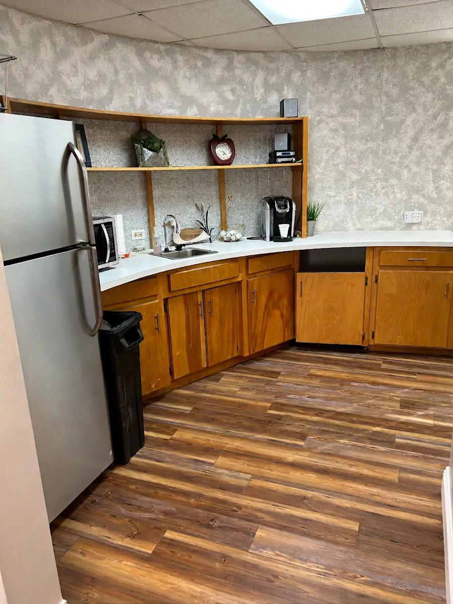 Commercial break room kitchen with wood flooring